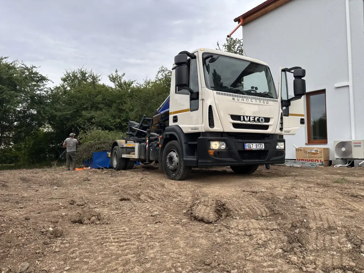 Iveco Kontejnerovka.cz na nezpevněném pozemku u rodinného domu